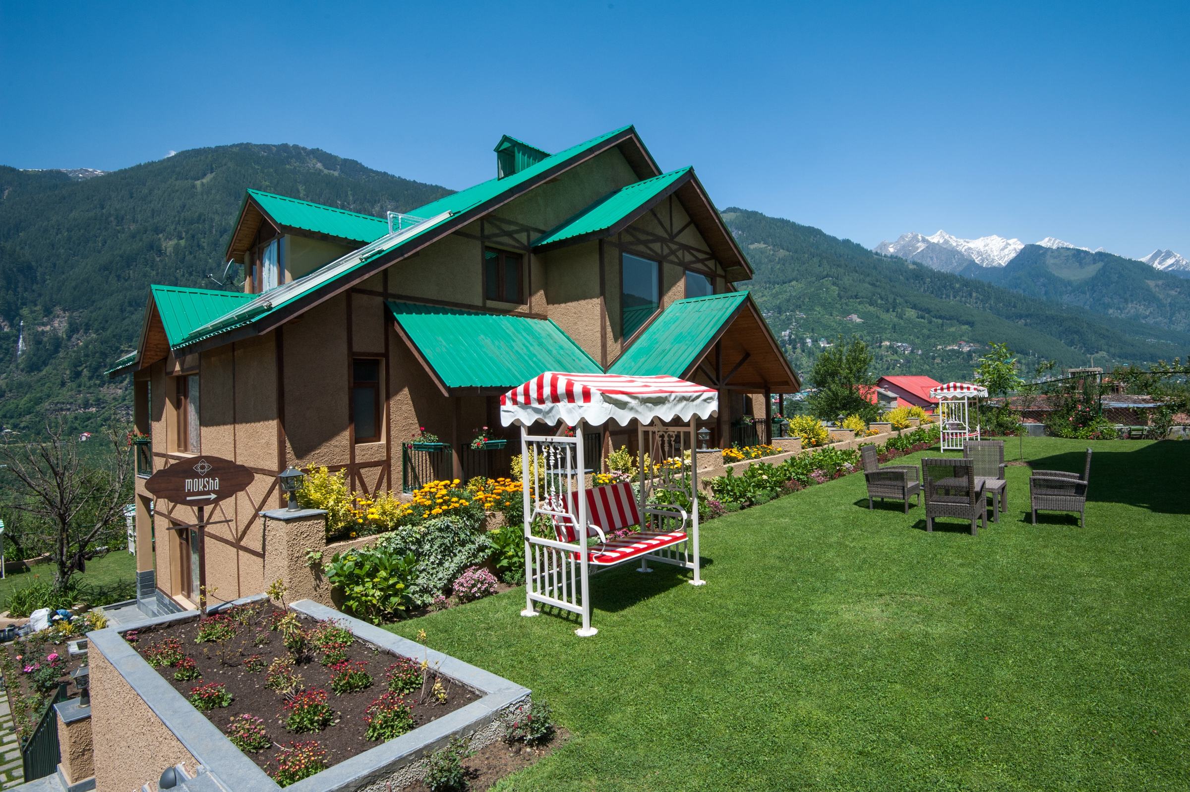 Villa with garden swing and snow peaks