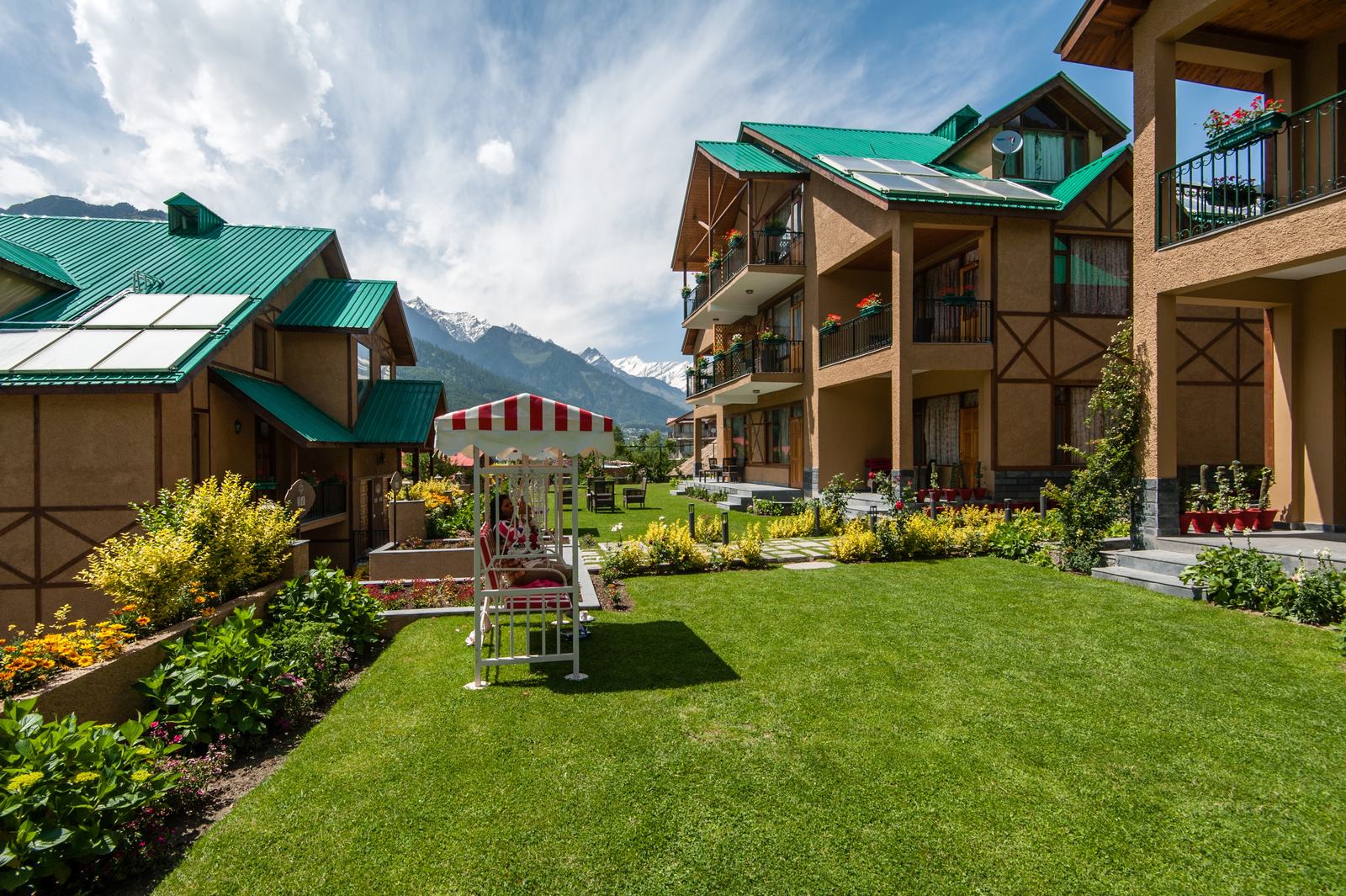 Lawns between the villas with clouds over the peaks