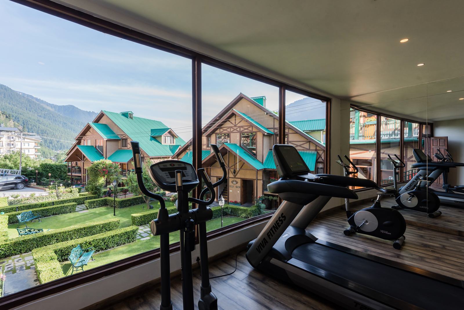 Gym with treadmills facing the cottages and valley